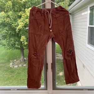 Lightly worn pink jeans, elastic waist and tie around waist.